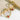 Harper Starburst gold plated hoop earrings with pink gemstones on a textured surface