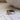 Set of two heart-shaped cuff rings in gold, silver, and black on a textured surface.
