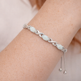 Opal infinity weave bolo bracelet with adjustable slider on a Models wrist