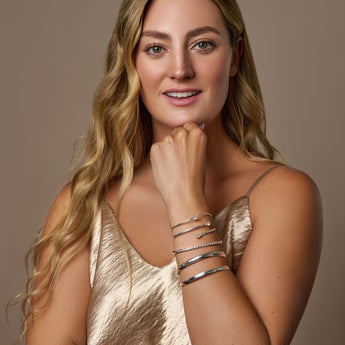 Urban Pizazz Model wearing a selection of sterling silver bangles