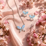 Sterling Silver Cubic Zirconia & Opal Butterfly Jewellery Set amongst cherry blossom
