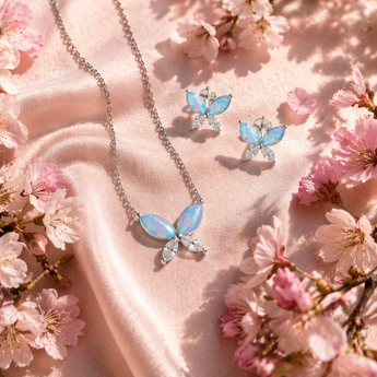Sterling Silver Cubic Zirconia & Opal Butterfly Jewellery Set amongst cherry blossom
