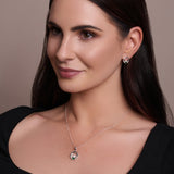 Urban Pizazz Model wearing our Sterling Silver May Birthstone Claddagh Pendant Necklace with Emerald Green Cubic Zirconia Heart Detail and Matching May Birthstone Claddagh CZ Earrings