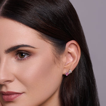 Urban Pizazz odel Wearing 925 Sterling Silver Stud Earrings in an Toi et Moi Design, featuring Pink and Clear Cubic Zirconia Stones