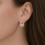 Urban Pizazz Model Wearing925 Sterling Silver and Rose Gold Teardrop Statement Stud Earrings with Cubic Zirconia Details