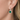 Urban Pizazz Model Wearing 925 Sterling Silver Emerald CZ Halo Drop Earrings