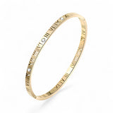 Gold plated bracelet with cubic zirconia accents on a white background