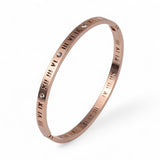 Rose gold plated bracelet with Roman numeral design on a white background