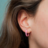 Amnesia Jewellery | Hot Pink Enamel Abi Hoop Earrings. Our Abi Hinged Hoop Earrings are made from gold plated stainless steel with a vibrant pink coloured enamel. Tarnish Free and Waterproof. Shop now for quality Jewellery/Jewelry!