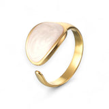 Gold plated ring with white liquid enamel on a white background