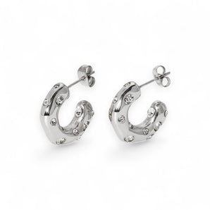 Stainless steel half hoop earrings with CZ stones on a white background