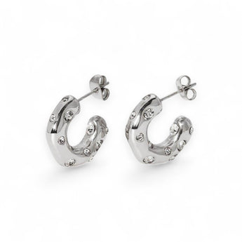 Stainless steel half hoop earrings with CZ stones on a white background