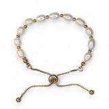 Embrace timeless coastal elegance with our Beach Pearl Bolo Bracelet. Featuring freshwater pearls delicately spaced with polished gold-toned beads, the adjustable bolo clasp ensures a comfortable fit for any wrist. Shop now for quality Jewellery/Jewelry!