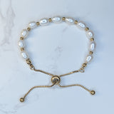 Embrace timeless coastal elegance with our Beach Pearl Bolo Bracelet. Featuring freshwater pearls delicately spaced with polished gold-toned beads, the adjustable bolo clasp ensures a comfortable fit for any wrist. Shop now for quality Jewellery/Jewelry!