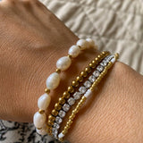 Embrace timeless coastal elegance with our Beach Pearl Bolo Bracelet. Featuring freshwater pearls delicately spaced with polished gold-toned beads, the adjustable bolo clasp ensures a comfortable fit for any wrist. Shop now for quality Jewellery/Jewelry!