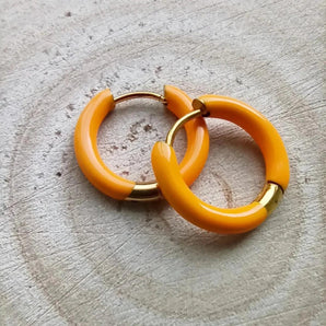 Amnesia Jewellery | Orange Enamel Cassie Hoop Earrings.Our Cassie Hinged Hoop Earrings are made from gold plated stainless steel with a vibrant orange coloured enamel. Tarnish Free and waterproof. Shop now for quality Jewellery/Jewelry!