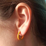 Amnesia Jewellery | Orange Enamel Cassie Hoop Earrings.Our Cassie Hinged Hoop Earrings are made from gold plated stainless steel with a vibrant orange coloured enamel. Tarnish Free and waterproof. Shop now for quality Jewellery/Jewelry!