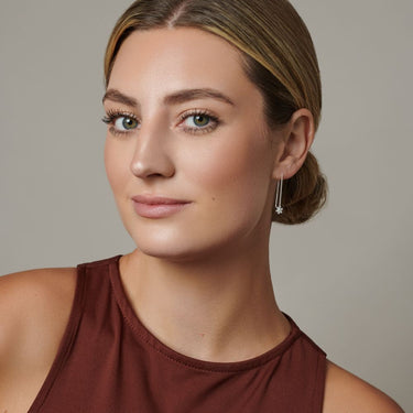 Woman wearing silver drop earrings