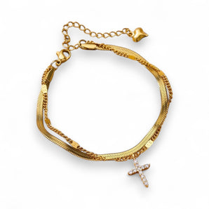 Our adorable Herringbone Cross Anklet! This sweet treasure features a cubic zirconia cross alongside a gold-plated herringbone chain. Tarnish Free and Waterproof