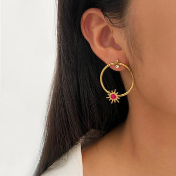 Harper Gold plated hoop earring with a red gemstone worn by a person