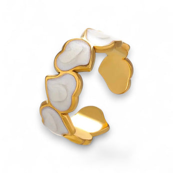 Gold plated with white liquid enamel cuff ring on a white background
