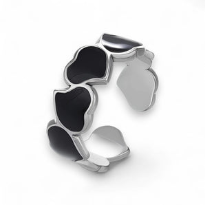 Stainless Steel cuff ring with black liquid enamel on a white background