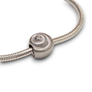 Sterling silver nautilus shell bead charm symbolising growth and renewal. Hypoallergenic, fits most charm bracelets - elegant and meaningful jewellery.