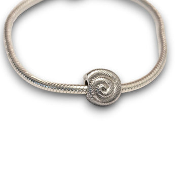 Sterling silver nautilus shell bead charm symbolising growth and renewal. Hypoallergenic, fits most charm bracelets - elegant and meaningful jewellery.