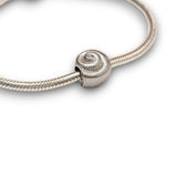 Sterling silver nautilus shell bead charm symbolising growth and renewal. Hypoallergenic, fits most charm bracelets - elegant and meaningful jewellery.