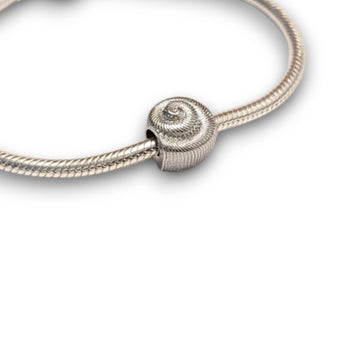 Sterling silver nautilus shell bead charm symbolising growth and renewal. Hypoallergenic, fits most charm bracelets - elegant and meaningful jewellery.