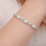 Opal infinity weave bolo bracelet with adjustable slider on a Models wrist