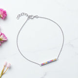 Rainbow Bar Bracelet – 925 Sterling Silver & CZ Stone by Urban Pizazz. Shop our 925 sterling silver Rainbow Bar Bracelet with vibrant CZ stones. Dainty, adjustable, hypoallergenic – perfect for layering or gifting in the UK.