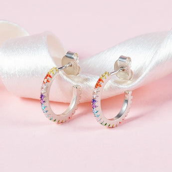 14mm Rainbow Hoop Earrings – 925 Silver & CZ Stones by Urban Pizazz. Shop 14mm rainbow hoop earrings in 925 sterling silver with colourful cubic zirconia. Bold, bright, and hypoallergenic—perfect for everyday sparkle!