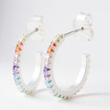 14mm Rainbow Hoop Earrings – 925 Silver & CZ Stones by Urban Pizazz. Shop 14mm rainbow hoop earrings in 925 sterling silver with colourful cubic zirconia. Bold, bright, and hypoallergenic—perfect for everyday sparkle!