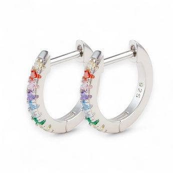10mm Rainbow Huggie Hoop Earrings – 925 Silver & CZ by Urban Pizazz. Shop 10mm rainbow huggie hoops in 925 sterling silver. Colorful cubic zirconia stones, dainty, hypoallergenic, and perfect for everyday sparkle.