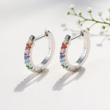 10mm Rainbow Huggie Hoop Earrings – 925 Silver & CZ by Urban Pizazz. Shop 10mm rainbow huggie hoops in 925 sterling silver. Colorful cubic zirconia stones, dainty, hypoallergenic, and perfect for everyday sparkle.