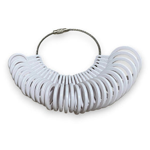 A keyring with a variety of white ring sizers A-Z arranged in a loop.