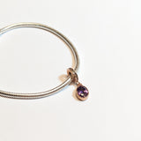Sterling silver charm with rose gold plating and an oval amethyst cubic zirconia. Hypoallergenic, elegant and perfect jewellery idea for charm bracelets.