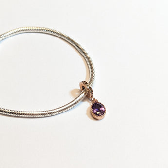 Sterling silver charm with rose gold plating and an oval amethyst cubic zirconia. Hypoallergenic, elegant and perfect jewellery idea for charm bracelets.