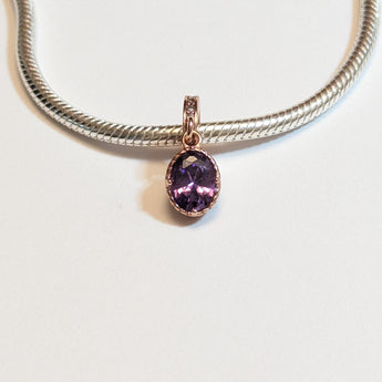 Sterling silver charm with rose gold plating and an oval amethyst cubic zirconia. Hypoallergenic, elegant and perfect jewellery idea for charm bracelets.