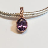 Sterling silver charm with rose gold plating and an oval amethyst cubic zirconia. Hypoallergenic, elegant and perfect jewellery idea for charm bracelets.