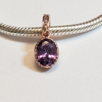 Sterling silver charm with rose gold plating and an oval amethyst cubic zirconia. Hypoallergenic, elegant and perfect jewellery idea for charm bracelets.