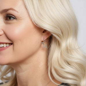 Model wearing Sterling Silver Cubic Zirconia Star Shaped Hoop Earrings