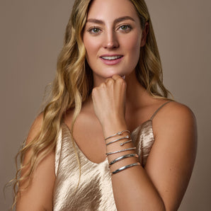 Urban Pizazz Model wearing a selection of sterling silver bangles