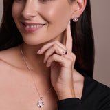 Urban Pizazz model wearing sterling silver claddagh jewellry featuring garnet red cubic zirconia heart centre stones