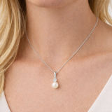 Urban Pizazz Model Wearin Sterling Silver Pearl and Cubic Zirconia Drop Pendant Necklace