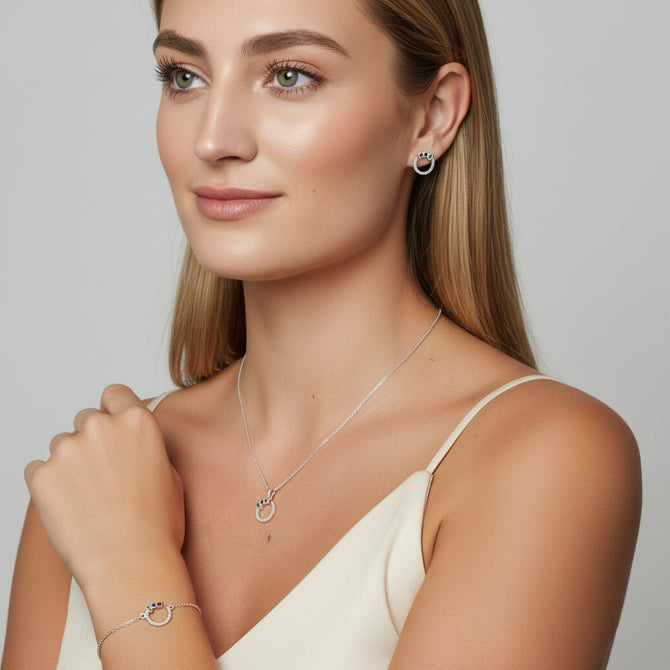 Urban Pizazz Model earing our Sterling Silver Open Circle Jewellery Set featuring a Pendant Necklace, Bracelet and Matching Earrings all with rainbow coloured cubic zirconia details