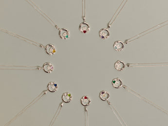 Collection of silver Claddagh necklaces  on a light gray background